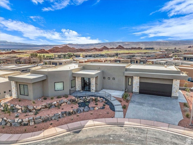 view of front of property with a garage and a mountain view