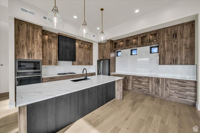 5367 W 3180 S, Hurricane, UT 84737 - kitchen with sink, hanging light fixtures, stainless steel appliances, light stone counters, and decorative backsplash