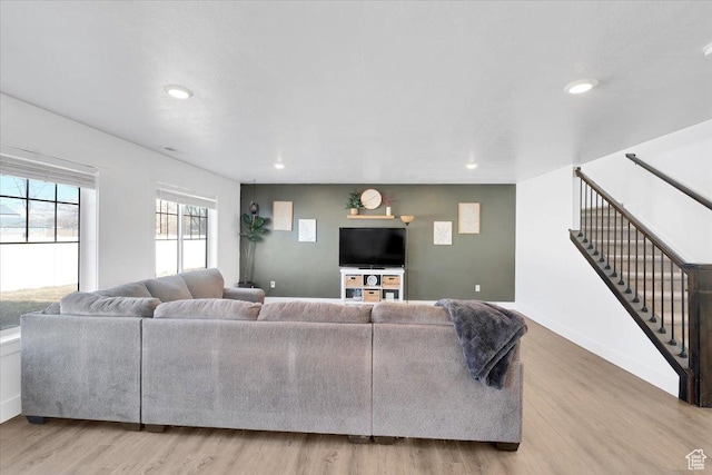 living area with stairway, recessed lighting, wood finished floors, and baseboards