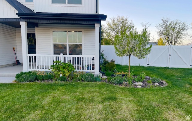 exterior space featuring a gate, a porch, and fence