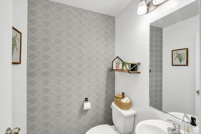 bathroom with toilet and a sink