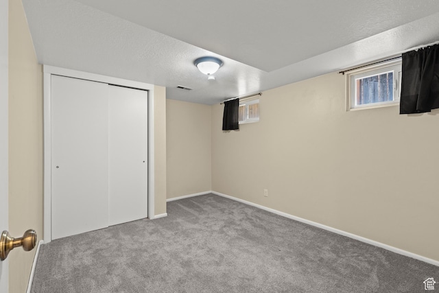 385 N 400 E, Logan, UT 84321 - basement with carpet floors, a textured ceiling, baseboards, and plenty of natural light