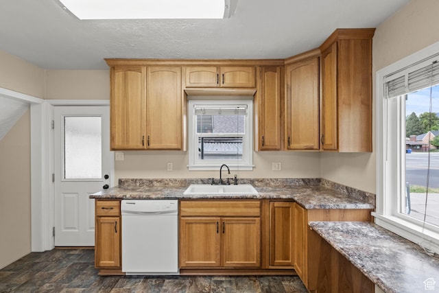 385 N 400 E, Logan, UT 84321 - kitchen with dishwasher, a sink, stone finish flooring, dark countertops, and brown cabinetry