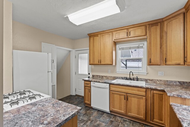 385 N 400 E, Logan, UT 84321 - kitchen with white appliances, a sink, and brown cabinets