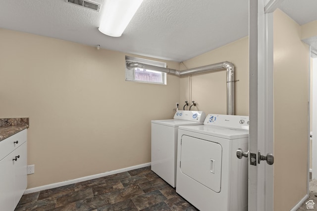 385 N 400 E, Logan, UT 84321 - laundry room with washer and dryer, baseboards, a textured ceiling, cabinet space, and dark stone finish floors