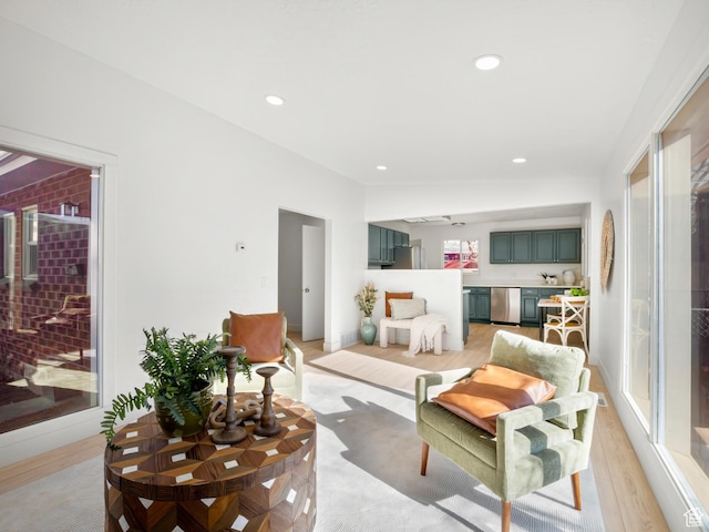 living room featuring vaulted ceiling and light hardwood / wood-style floors