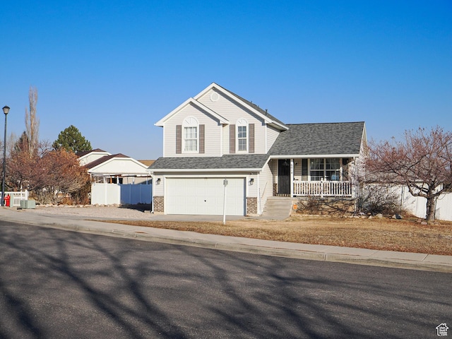 tri-level home featuring a garage and a porch