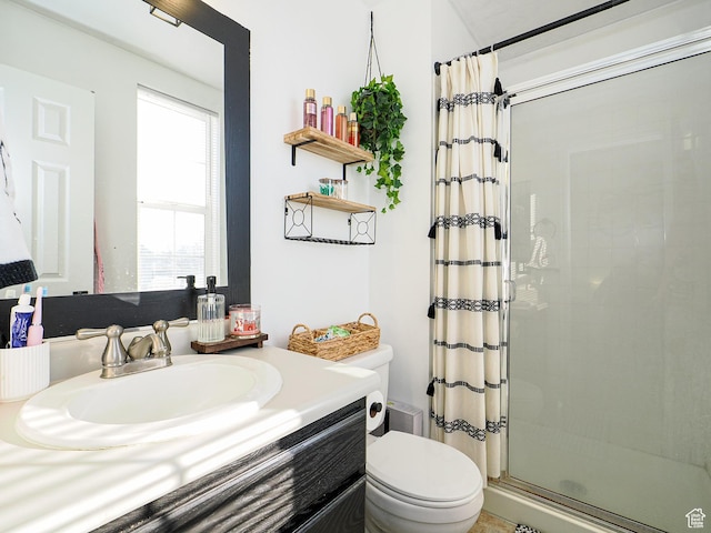 bathroom featuring vanity, curtained shower, and toilet
