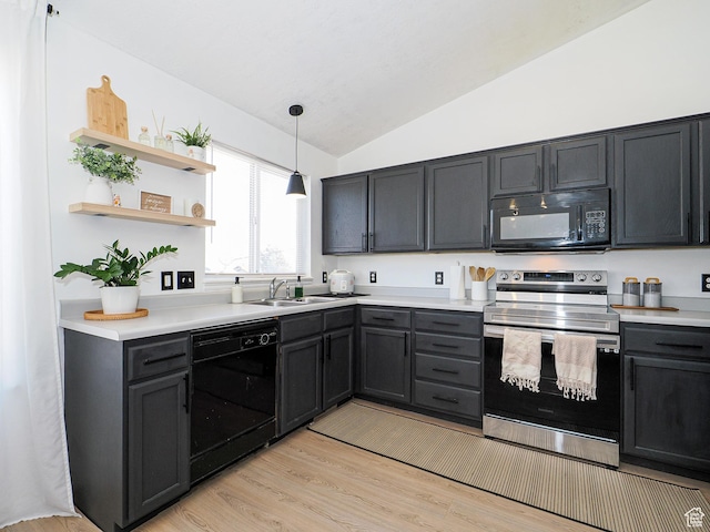 kitchen with sink, vaulted ceiling, light wood-type flooring, pendant lighting, and black appliances