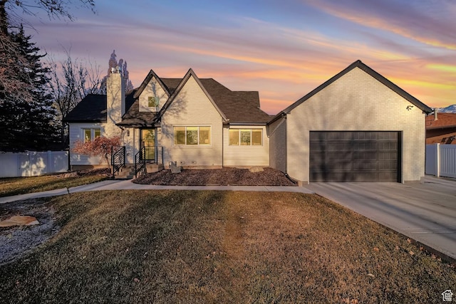 view of front of house with a garage and a yard
