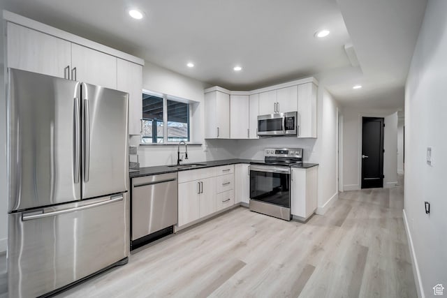 1489 E Spring Ln S, Holladay, UT 84117 - kitchen with stainless steel appliances, light hardwood / wood-style floors, sink, and white cabinets