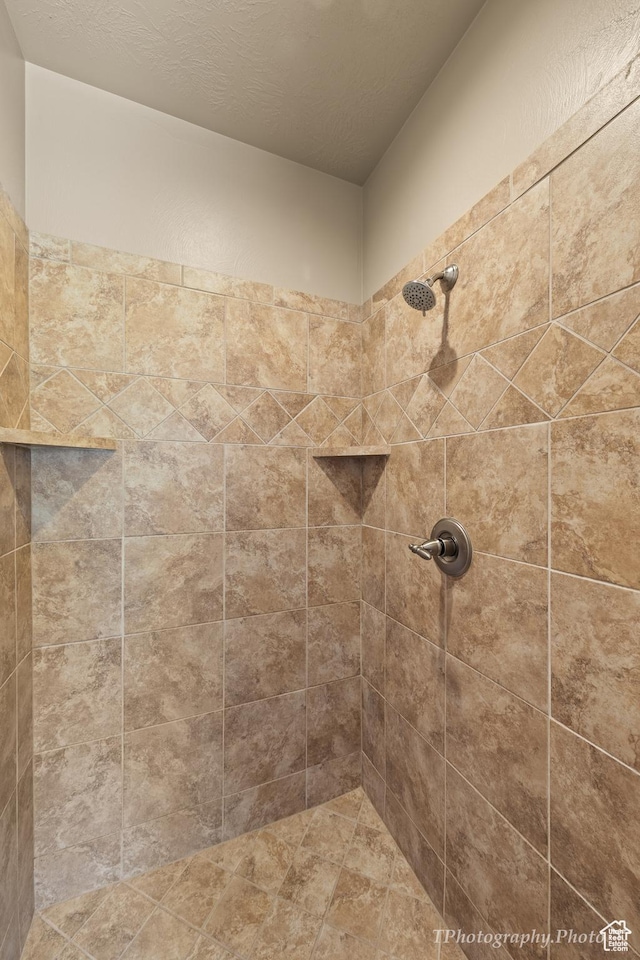 bathroom with tiled shower