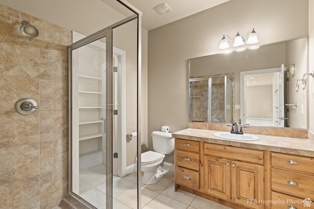bathroom featuring vanity, an enclosed shower, tile patterned floors, and toilet