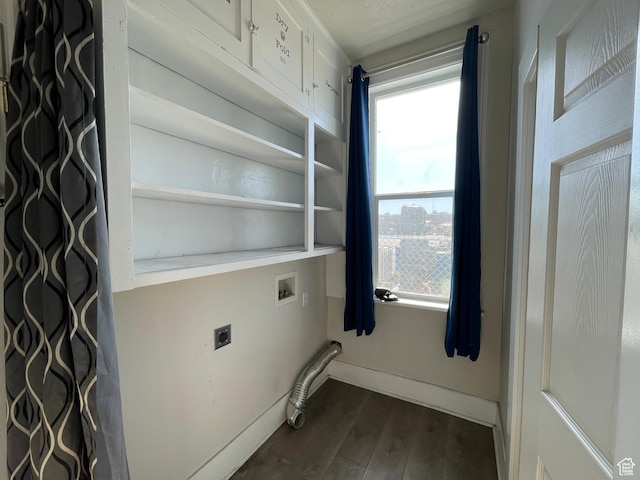 laundry area with cabinet space, hookup for an electric dryer, dark wood-type flooring, hookup for a washing machine, and baseboards