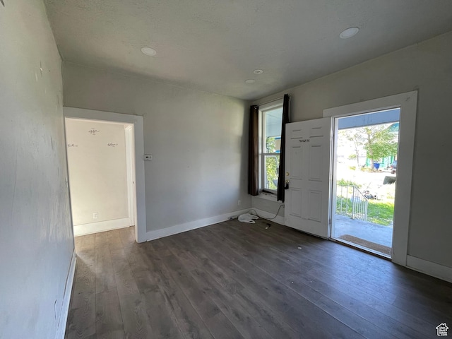 entryway with hardwood / wood-style floors, baseboards, and recessed lighting