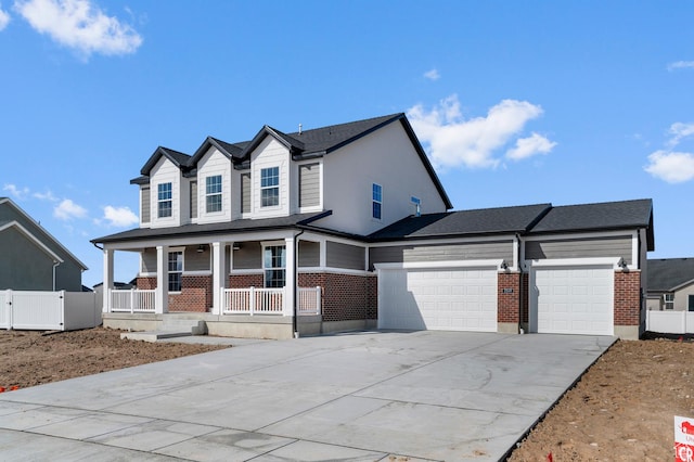 view of front of house with fence, a porch, an attached garage, concrete driveway, and brick siding