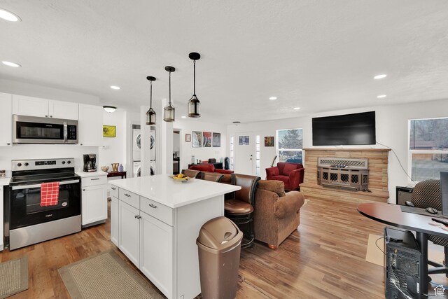 870 E Vics Rd, Sandy, UT 84094 - kitchen featuring stainless steel appliances, a center island, pendant lighting, and white cabinets