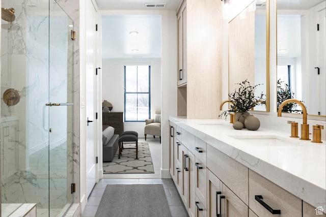 bathroom featuring an enclosed shower, vanity, and tile patterned floors