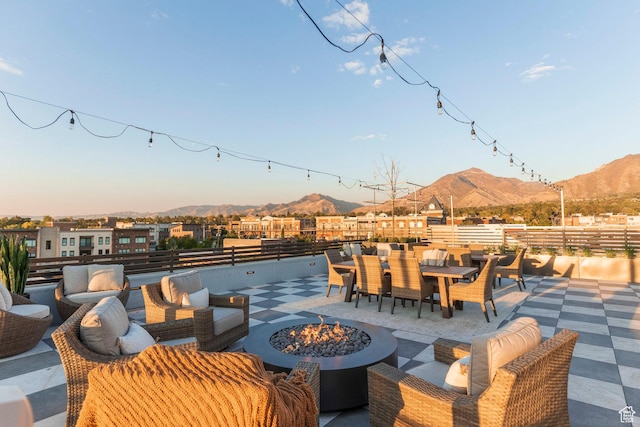 view of patio / terrace featuring a mountain view and a fire pit