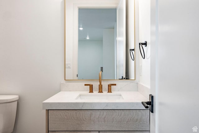 bathroom featuring vanity and toilet
