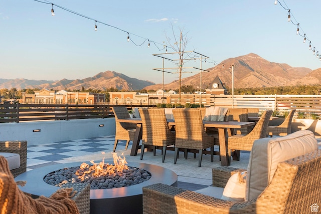 exterior space with a mountain view and a fire pit