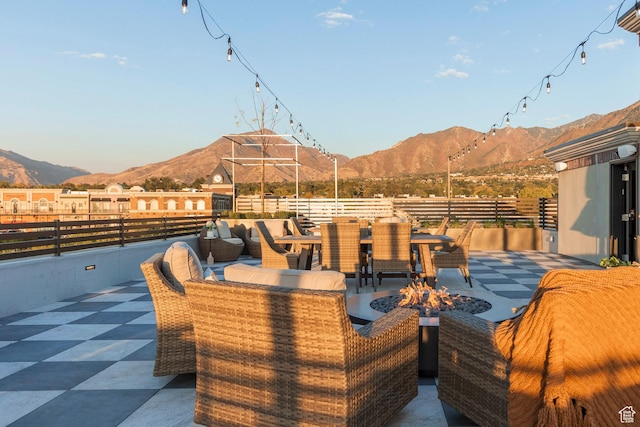 view of patio / terrace with a mountain view and a fire pit