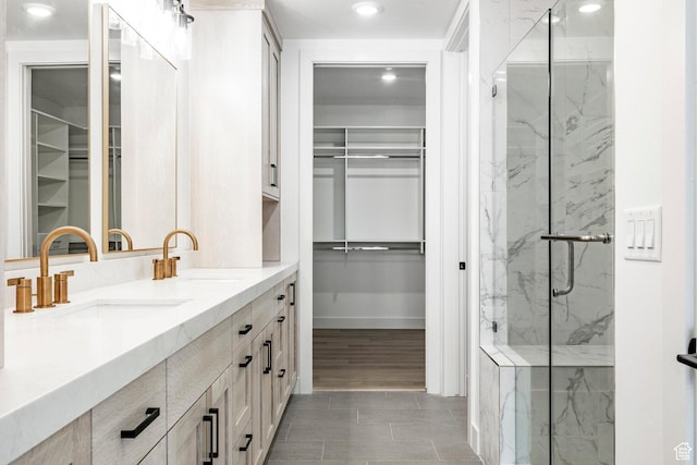 bathroom with vanity and a shower with shower door