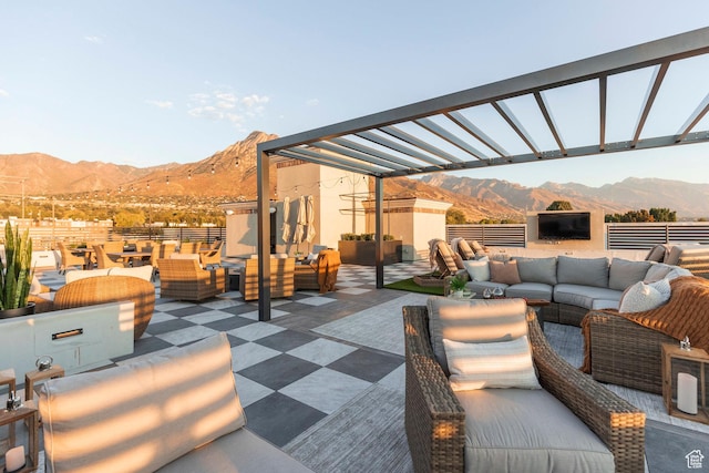 view of patio with a pergola, outdoor lounge area, and a mountain view