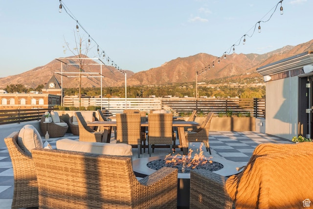 view of patio / terrace featuring a mountain view and a fire pit