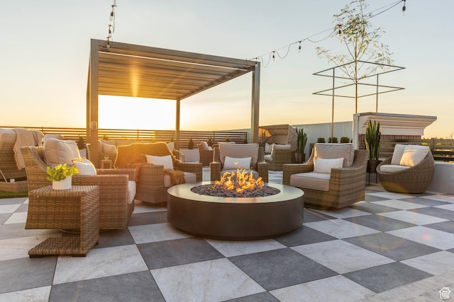 patio terrace at dusk featuring an outdoor living space with a fire pit