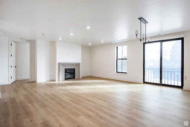unfurnished living room with light hardwood / wood-style floors