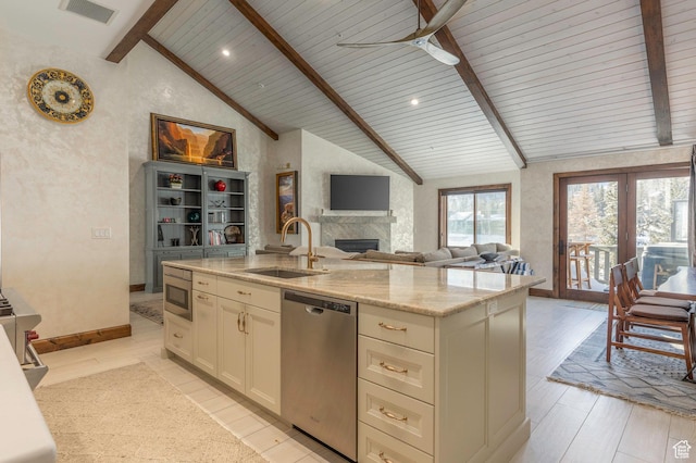 kitchen with stainless steel appliances, a sink, beamed ceiling, visible vents, and a ceiling fan