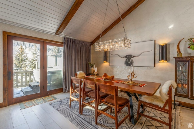 dining area featuring an inviting chandelier, lofted ceiling with beams, and wooden ceiling