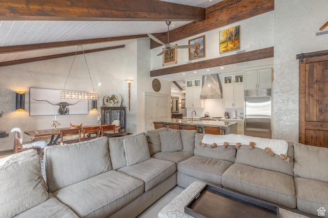 living area featuring high vaulted ceiling, a ceiling fan, and beam ceiling