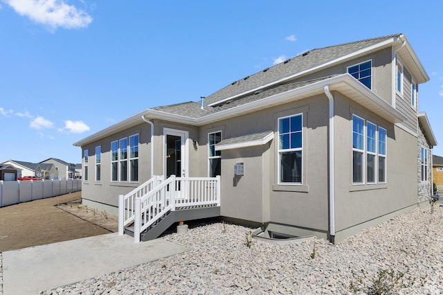 rear view of property with fence