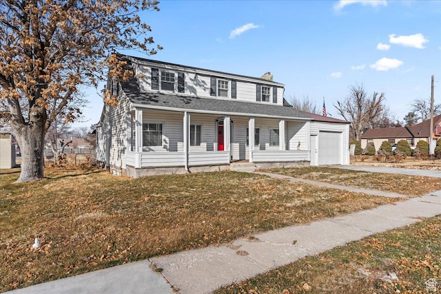 view of front facade with a garage, a front yard, and covered porch