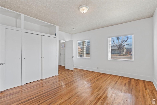 unfurnished bedroom with hardwood / wood-style flooring and a closet