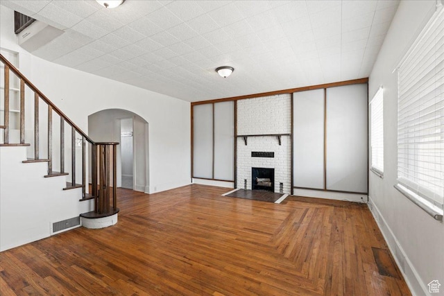 unfurnished living room with hardwood / wood-style flooring and a fireplace