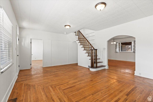 unfurnished room featuring parquet flooring and a notable chandelier
