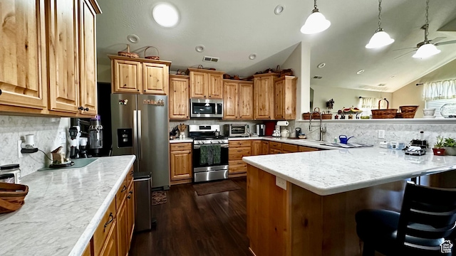 929 W 1920 S Unit A, Syracuse, UT 84075 - kitchen with vaulted ceiling, a breakfast bar, backsplash, hanging light fixtures, and stainless steel appliances