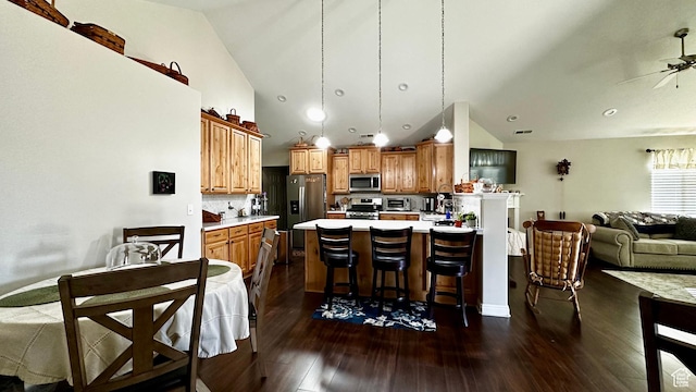 929 W 1920 S Unit A, Syracuse, UT 84075 - kitchen featuring appliances with stainless steel finishes, a breakfast bar area, decorative backsplash, hanging light fixtures, and ceiling fan