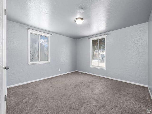 320 W Washington Ave S, American Fork, UT 84003 - empty room featuring a textured ceiling and dark colored carpet