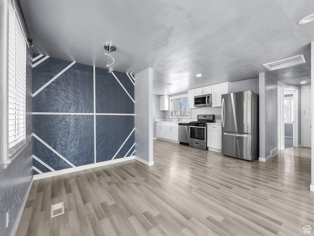 320 W Washington Ave S, American Fork, UT 84003 - kitchen featuring white cabinetry, appliances with stainless steel finishes, sink, and light hardwood / wood-style floors