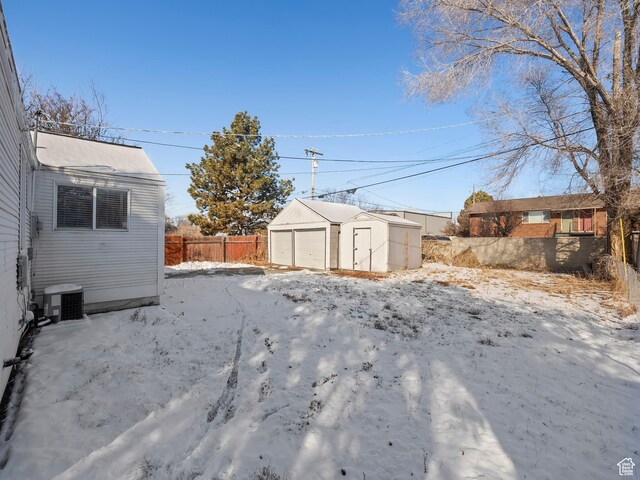 320 W Washington Ave S, American Fork, UT 84003 - yard covered in snow featuring a garage, an outbuilding, and cooling unit
