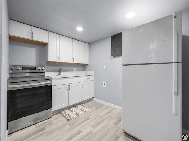 320 W Washington Ave S, American Fork, UT 84003 - kitchen with white cabinetry, sink, stainless steel electric range oven, and white refrigerator