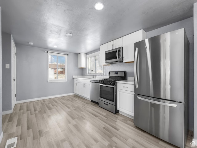 320 W Washington Ave S, American Fork, UT 84003 - kitchen featuring white cabinetry, appliances with stainless steel finishes, and light hardwood / wood-style floors