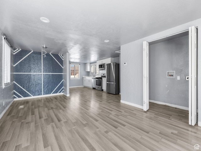 320 W Washington Ave S, American Fork, UT 84003 - unfurnished living room featuring sink and light wood-type flooring