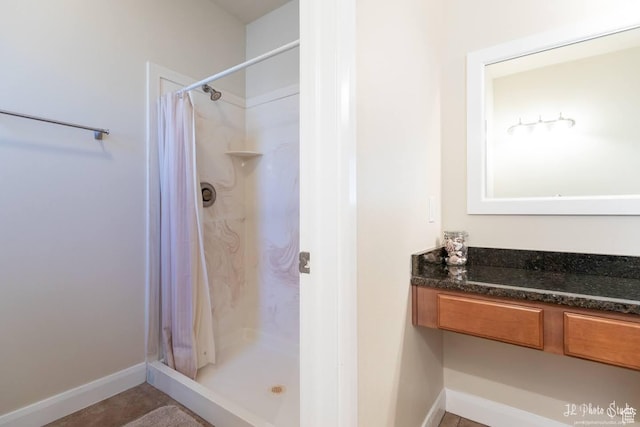 bathroom with curtained shower and tile patterned floors