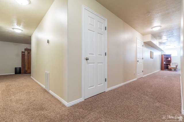 hall featuring carpet