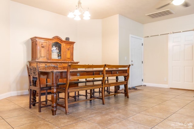 dining area featuring an inviting chandelier and light tile patterned floors